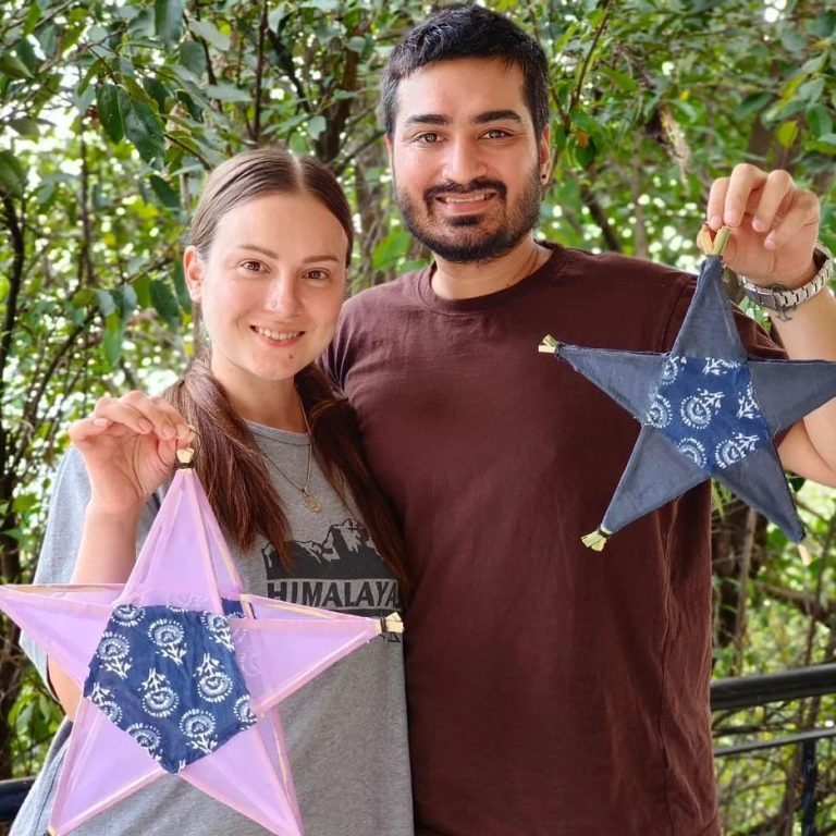 The image shows a digital nomad couple in India at a digital nomad community event in himachal