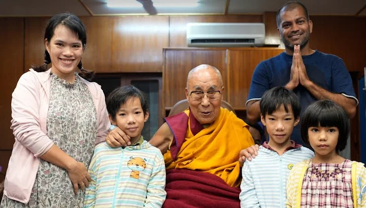 The image shows digital nomads in india meeting with the Dalai Lama