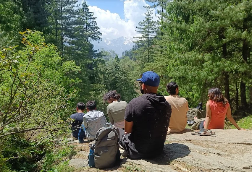 The image shows digital nomads in India in a forest in Naggar Himachal Pradesh India