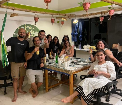 The image shows the digital nomad community doing a potluck in Goa, India