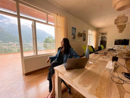 The image shows a digital nomad in the coworking space in Dharamkot