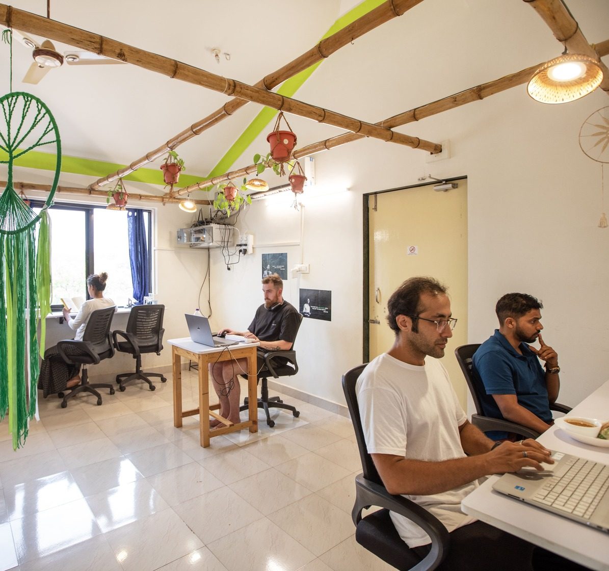 The image shows an indoor coworking space in Goa India