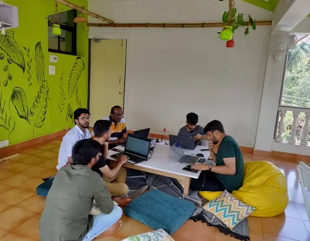 the image shows a remote team in a coliving space goa india