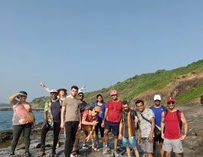 The image shows a digital nomad community on a trek in Goa, India