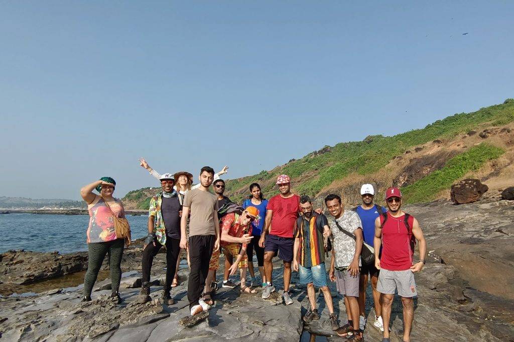 The image shows a digital nomad community on a trek in Goa, India